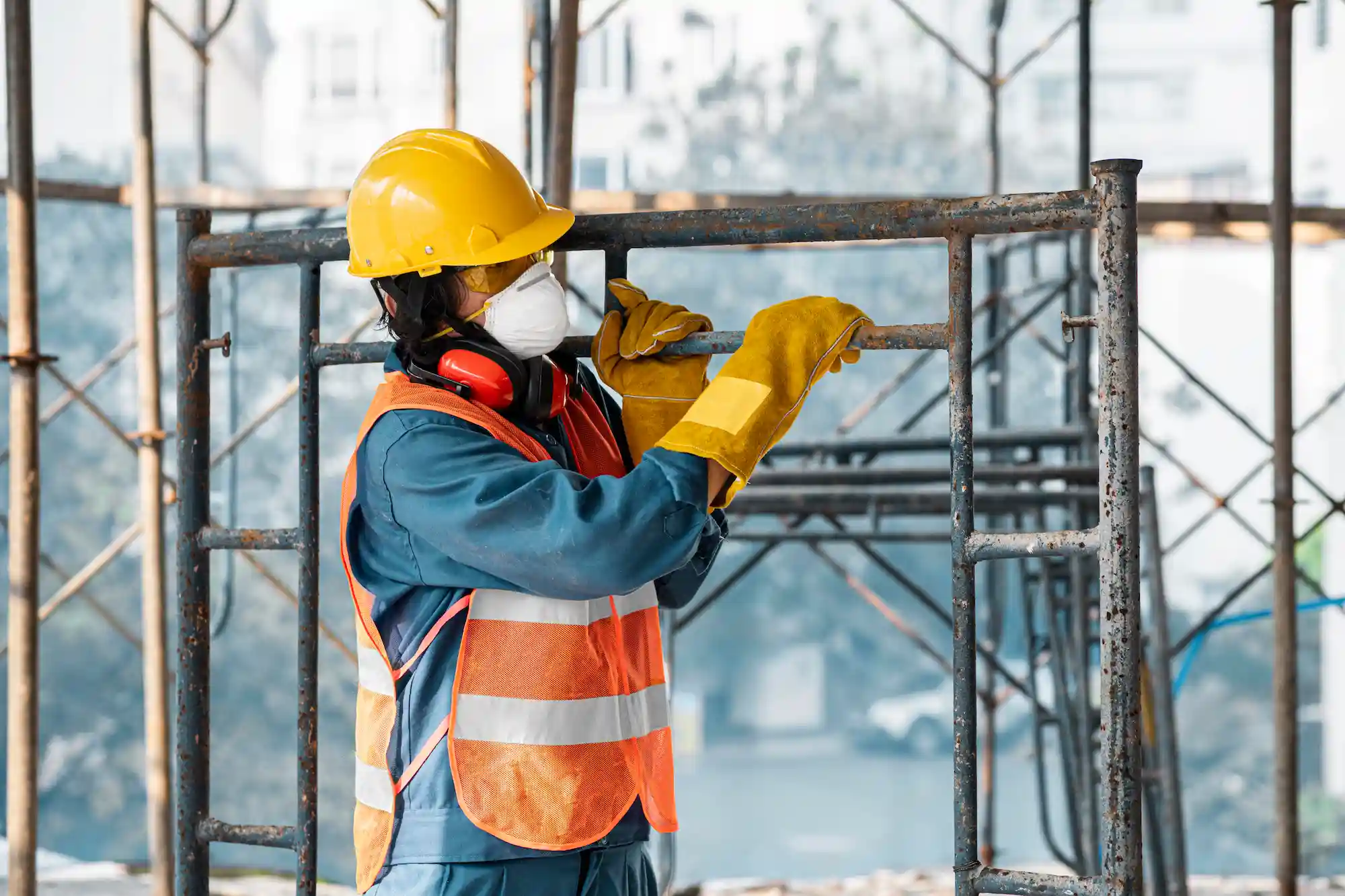 Fremont Scaffolding Rental worker installing scaffolding equipment wearing safety gear and helmet